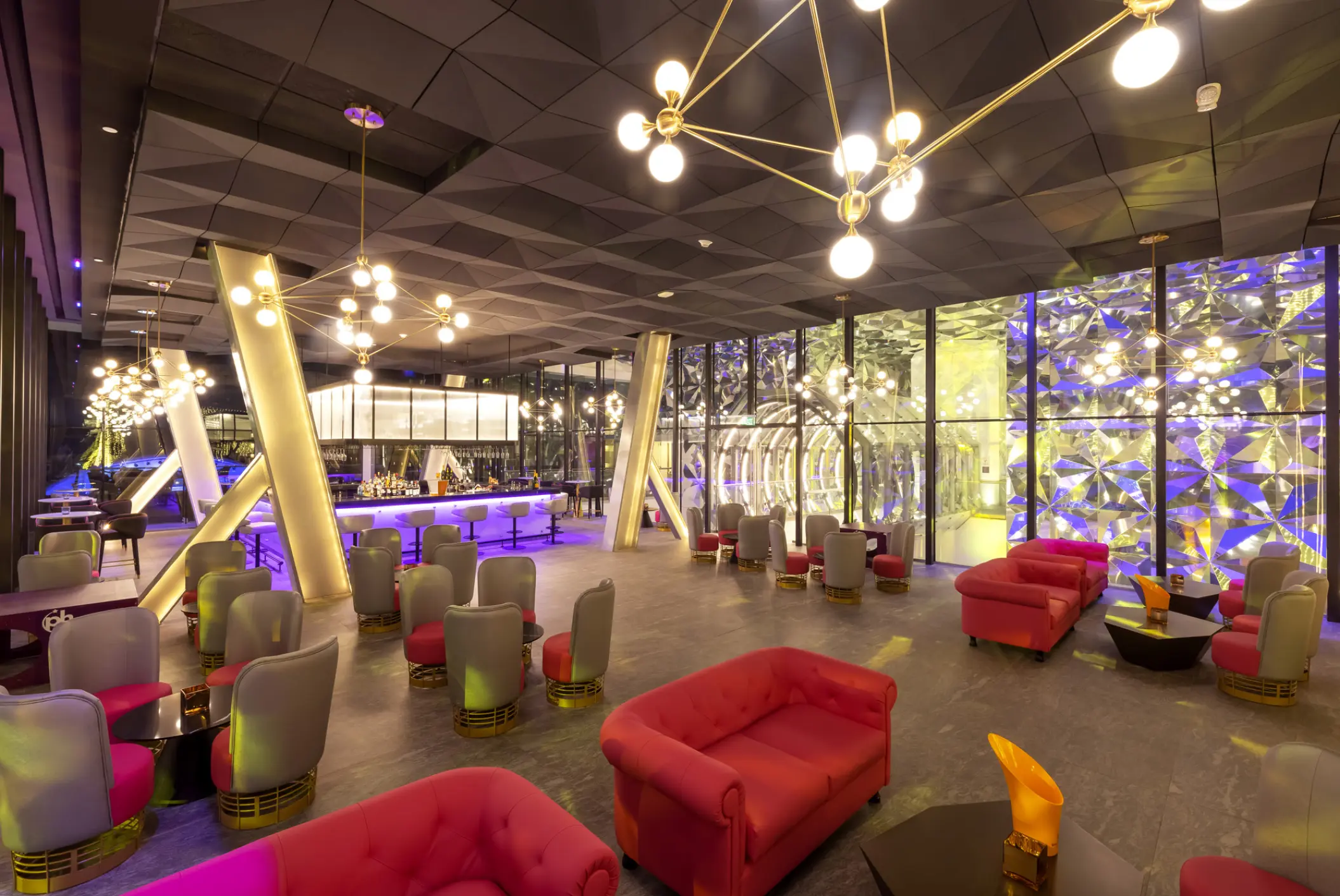 Modern indoor lounge with pink and grey seating at Planet Hollywood Cancun
