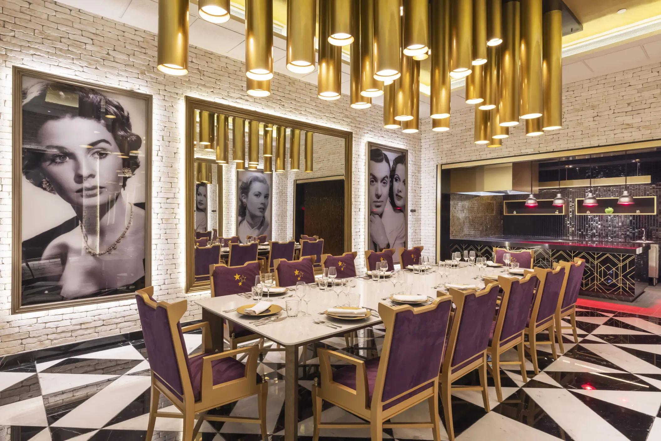 Long dining table with purple chairs and gold pendant lights at Planet Hollywood Cancun