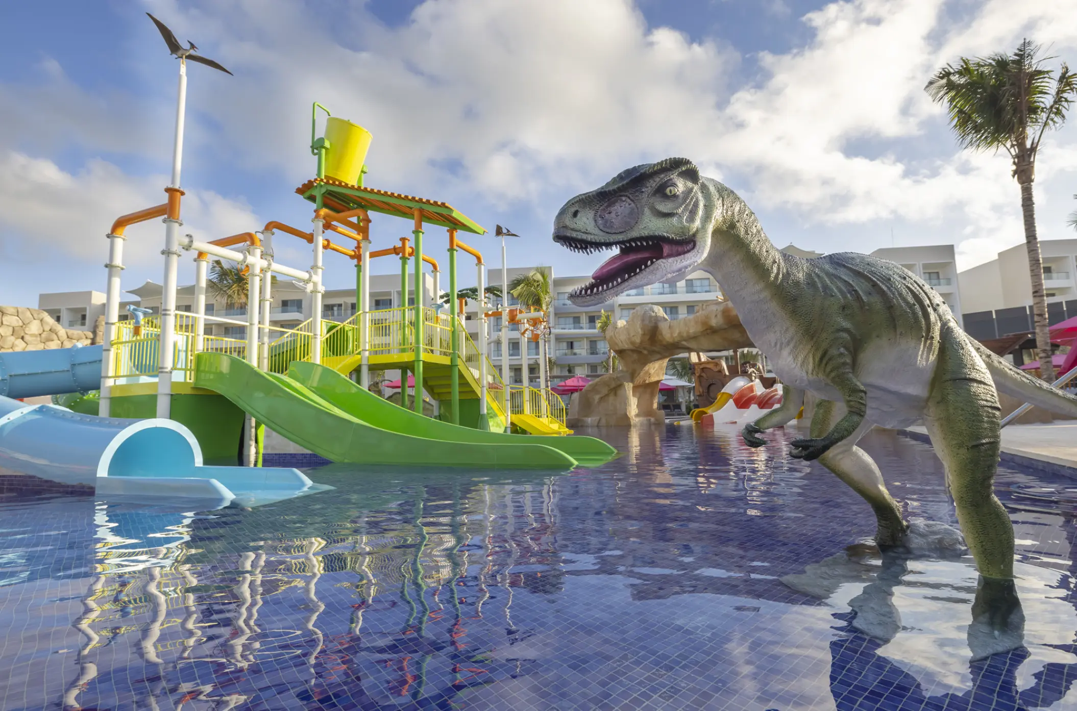 Dinosaur-themed splash park with water slides at Planet Hollywood Cancun