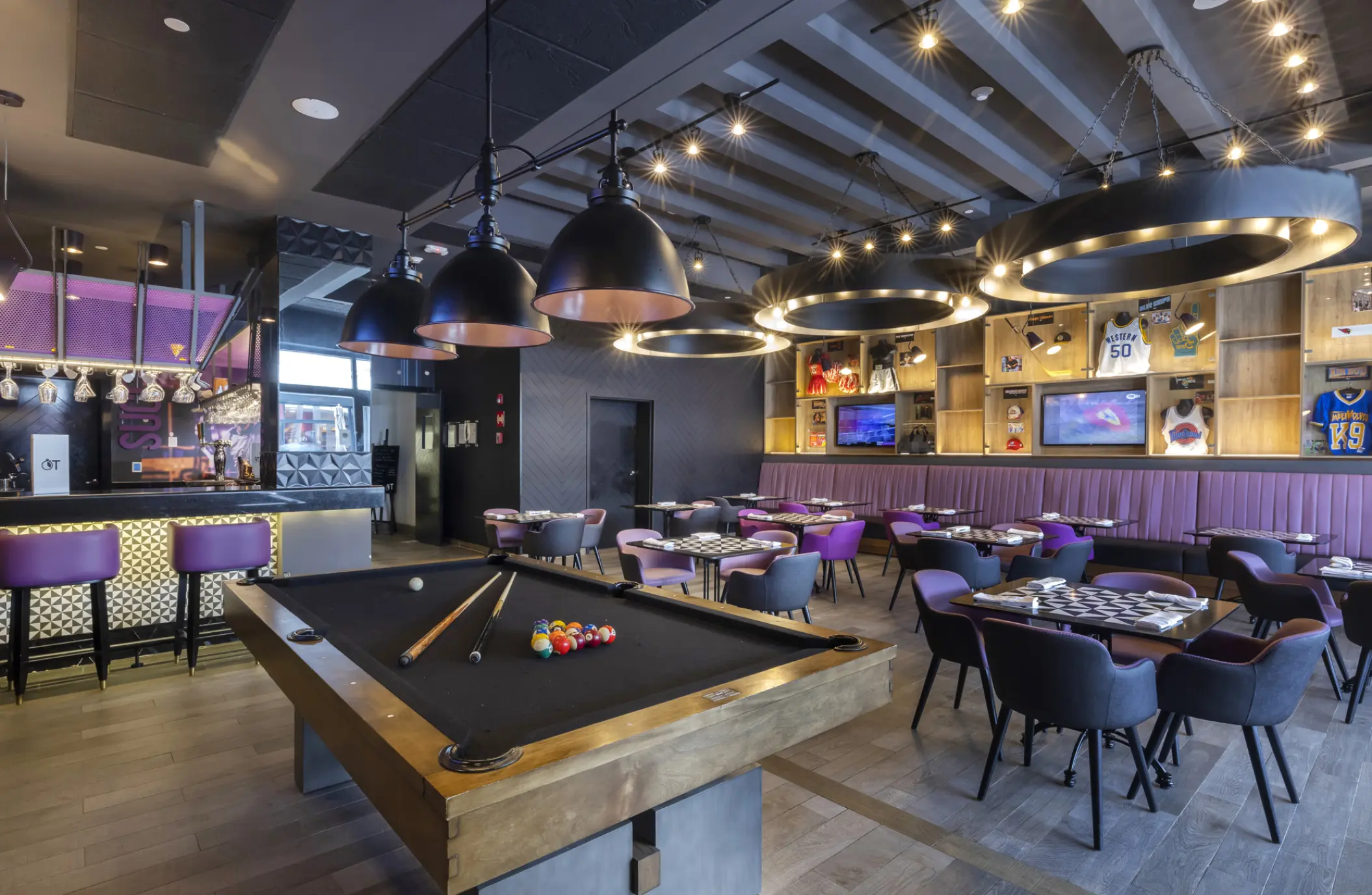 Sports bar with a pool table and purple seating at Planet Hollywood Cancun, Cancun