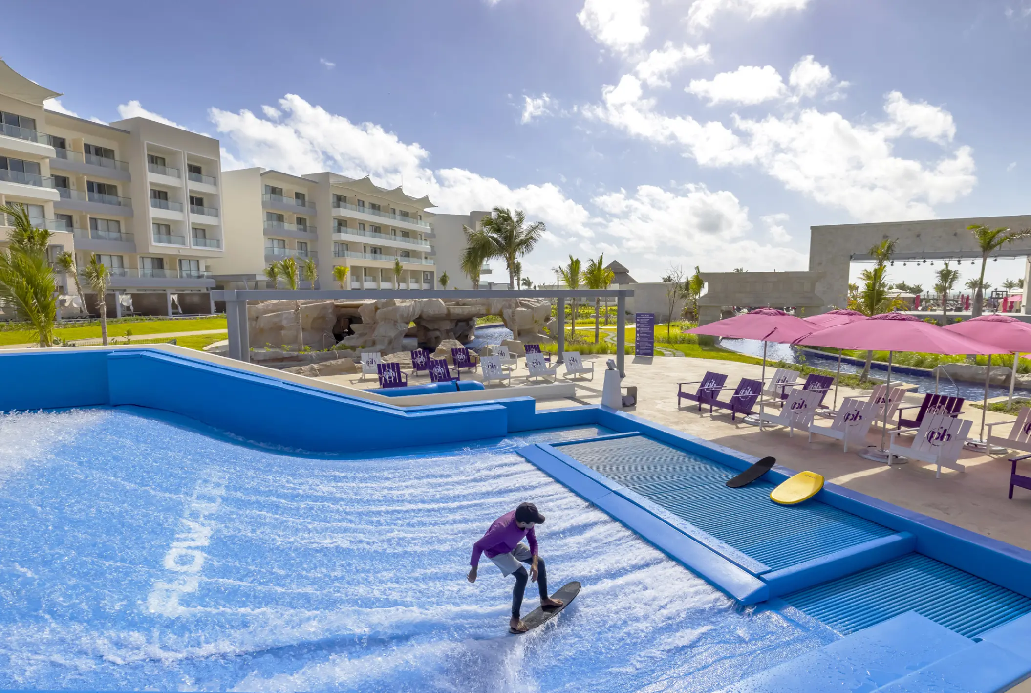 FlowRider surf simulator with a guest riding a wave at Planet Hollywood Cancun