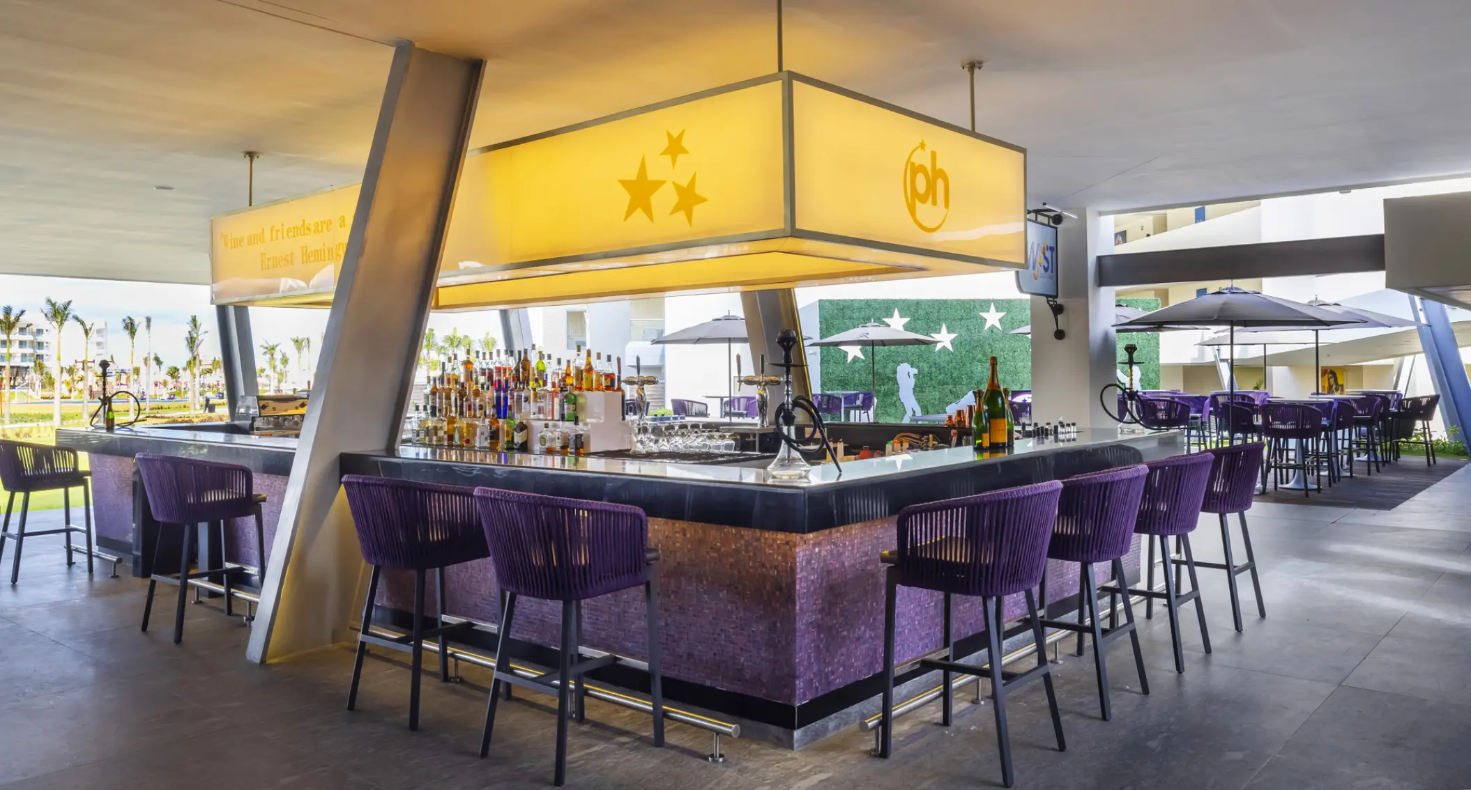 Twist Social Bar with purple seating and neon lighting at Planet Hollywood Cancun