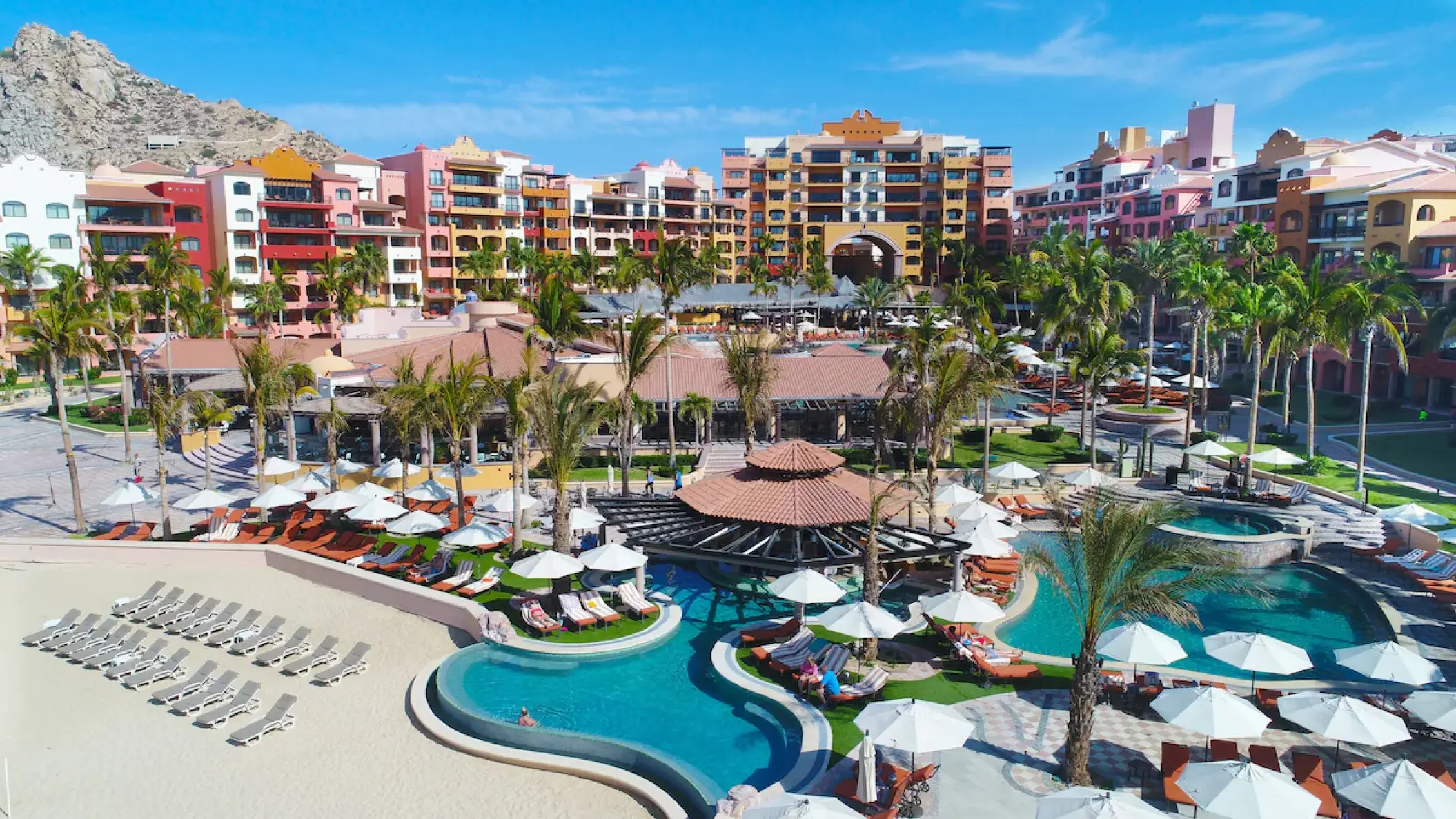 Playa Grande Resort exterior and swimming pools with white umbrellas, Cabo San Lucas