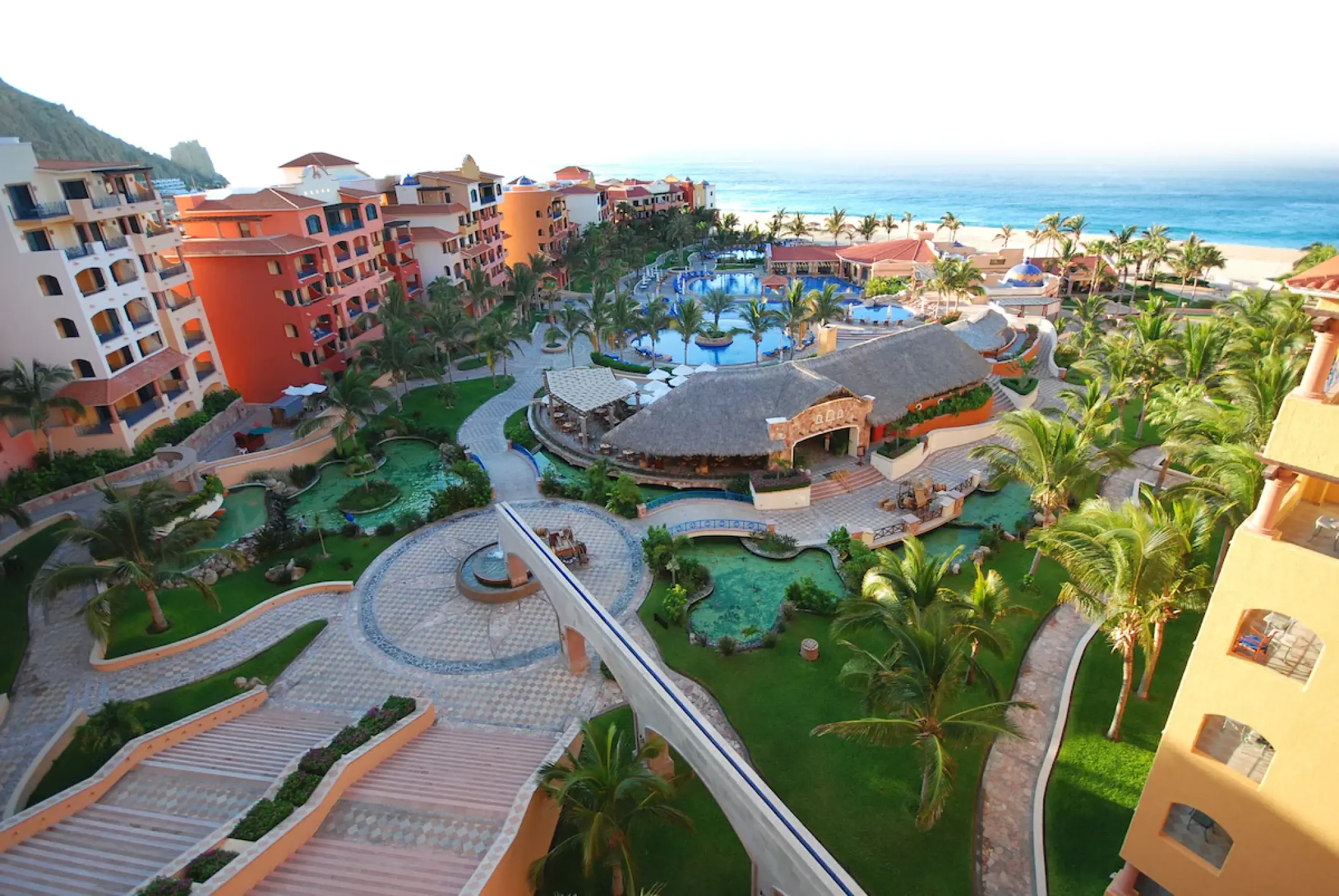 Playa Grande Resort aerial view of pools, beachfront buildings and palm trees, Cabo San Lucas