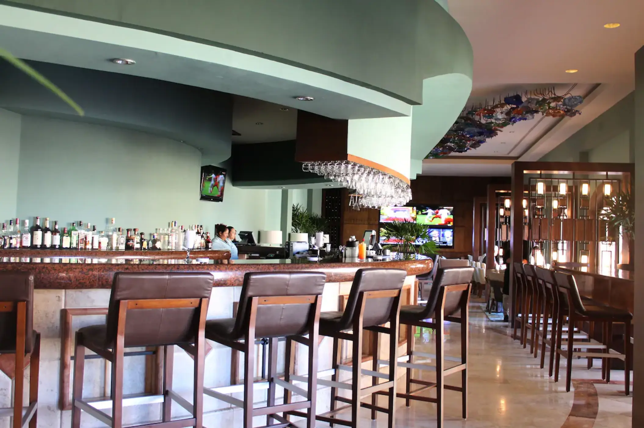 Playa Grande Resort indoor bar with leather stools and marble flooring, Cabo San Lucas