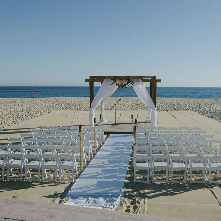 Beachfront wedding ceremony setup at Playa Grande Resort, Cabo San Lucas
