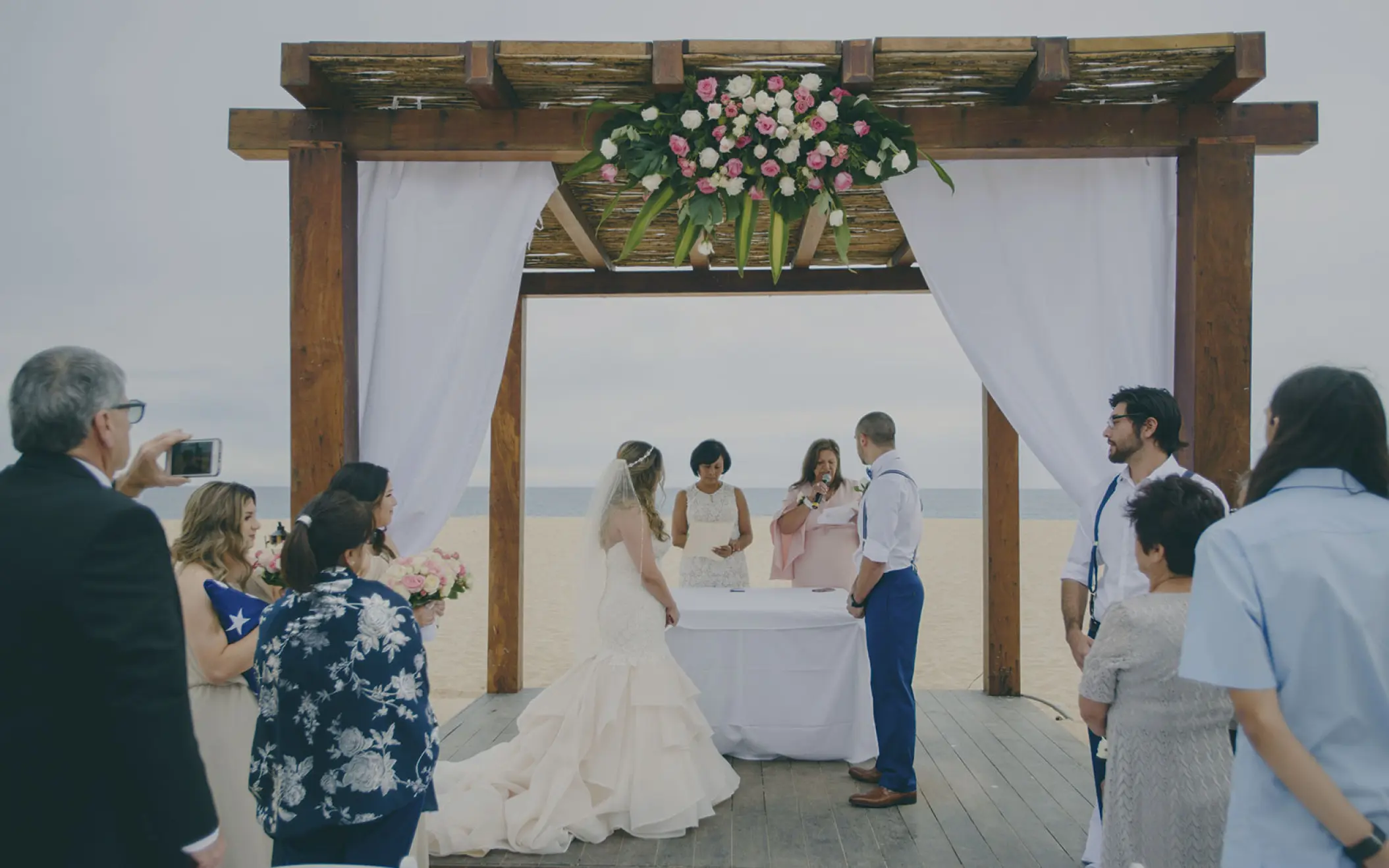 Beachfront wedding ceremony under a wooden gazebo at Playa Grande Resort, Cabo San Lucas