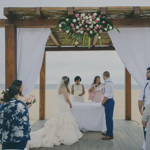Beachfront wedding ceremony under a wooden gazebo at Playa Grande Resort, Cabo San Lucas