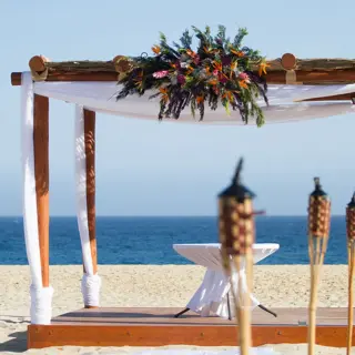 Beachfront wedding ceremony gazebo with floral decor at Playa Grande Resort, Cabo San Lucas
