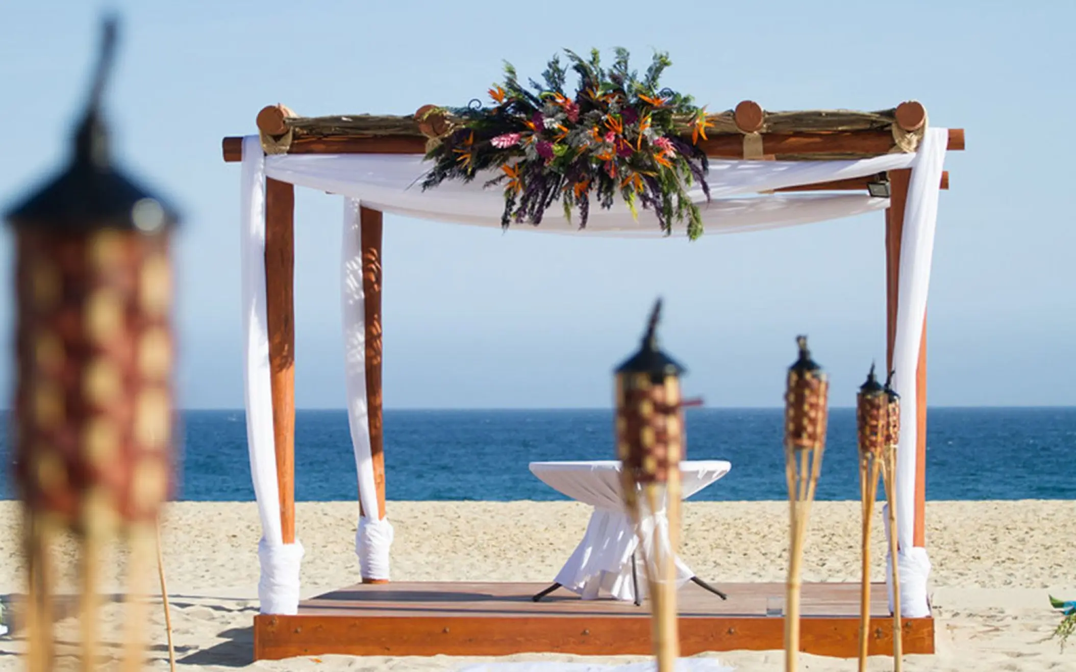 Beachfront wedding ceremony gazebo with floral decor at Playa Grande Resort, Cabo San Lucas