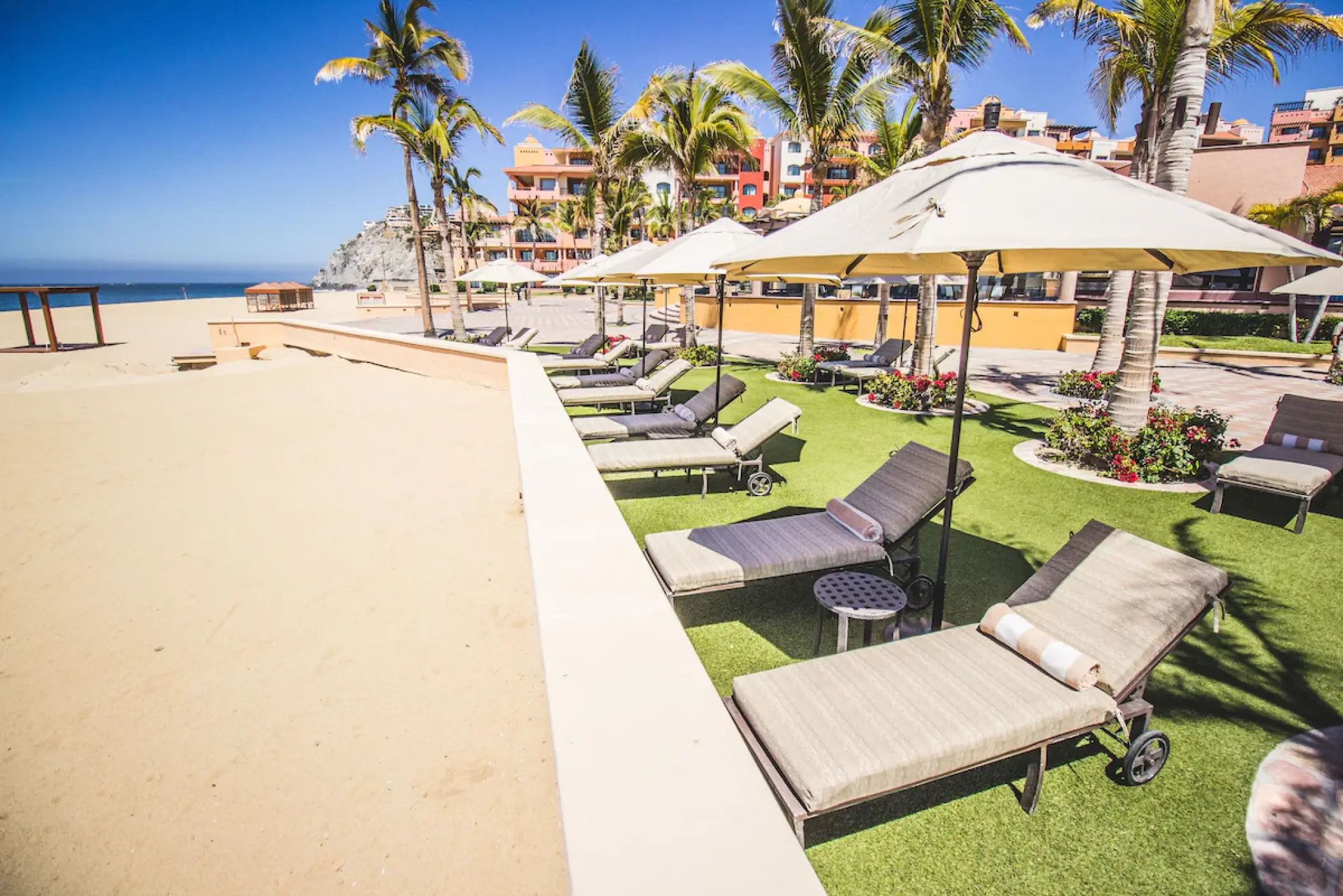 Playa Grande Resort beachfront lounge chairs and umbrellas, Cabo San Lucas