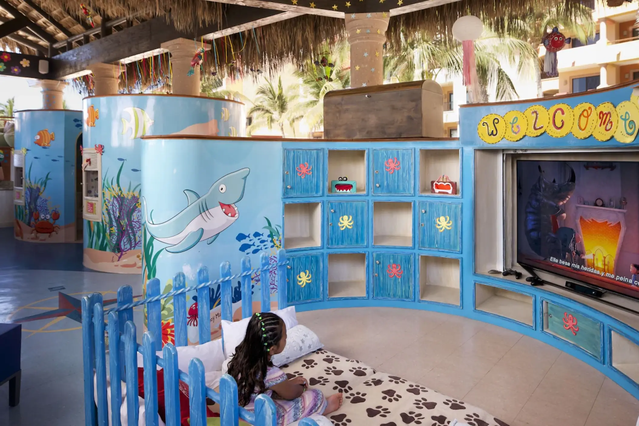 Child watching a movie in the themed kids club at Playa Grande Resort, Cabo San Lucas