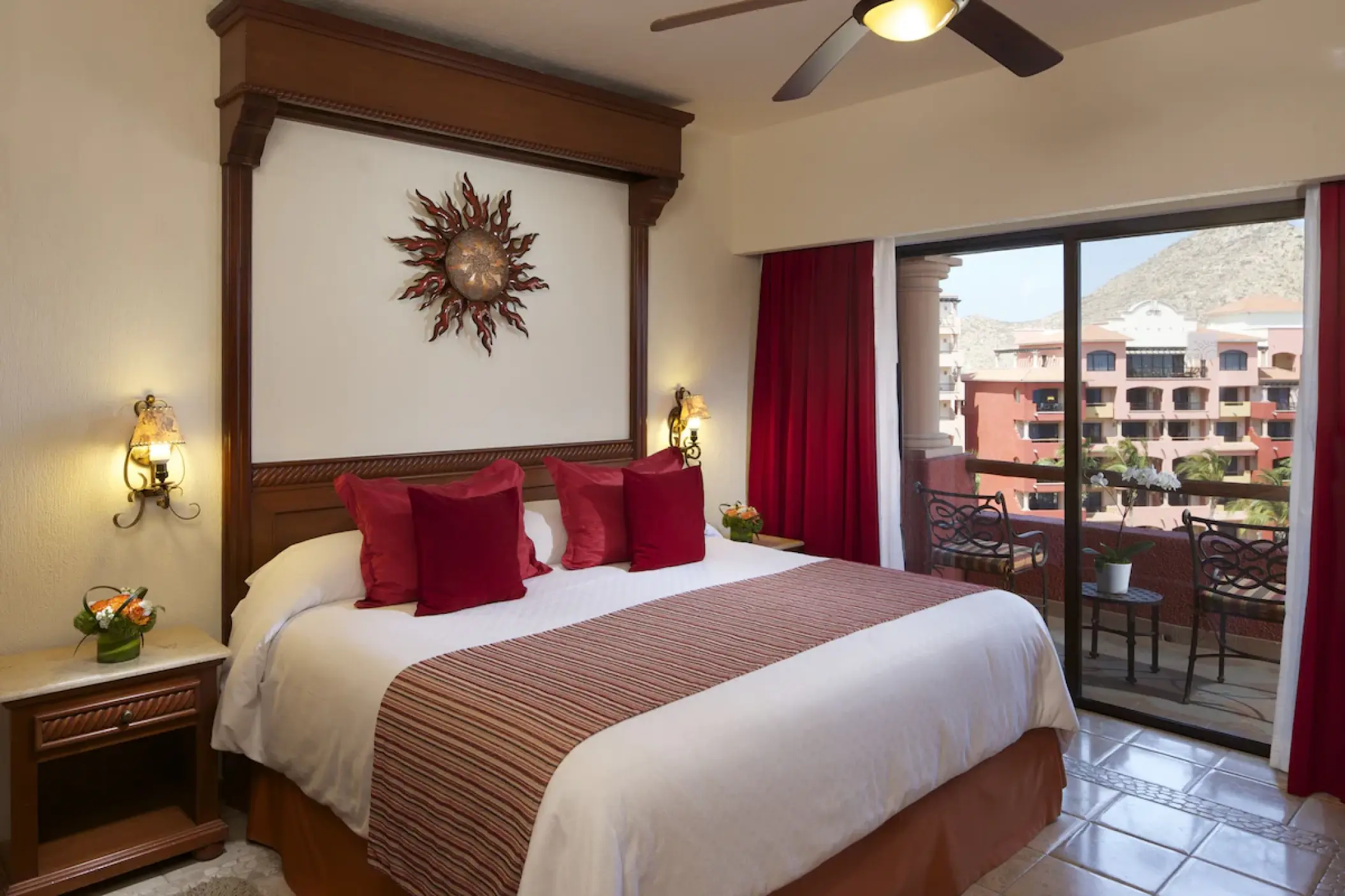 Guest suite with red accents and a private balcony at Playa Grande Resort, Cabo San Lucas