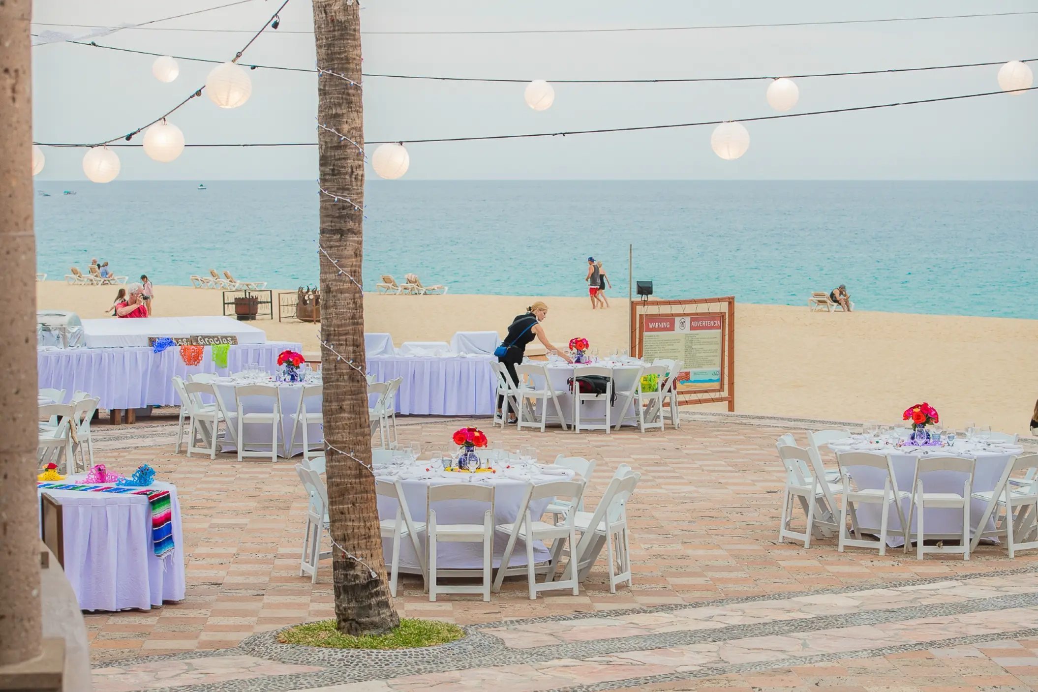Terrace wedding reception with paper lanterns and ocean views at Playa Grande Resort, Cabo San Lucas