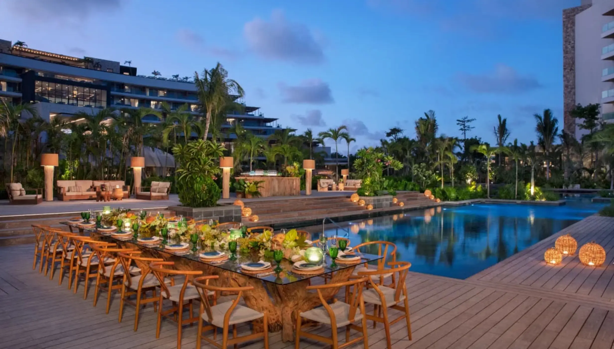 Outdoor wedding reception dinner set up on the pool deck at Impression Moxché by Secrets, Playa Del Carmen
