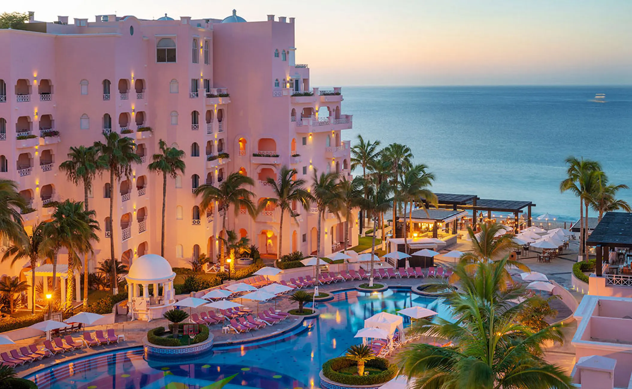 Pueblo Bonito Rose pink buildings and pool area overlooking the ocean at sunset, Cabo San Lucas