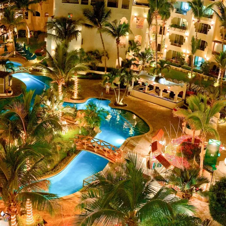 Aerial view of the illuminated main pool and palm trees at night at Pueblo Bonito Los Cabos, Cabo San Lucas