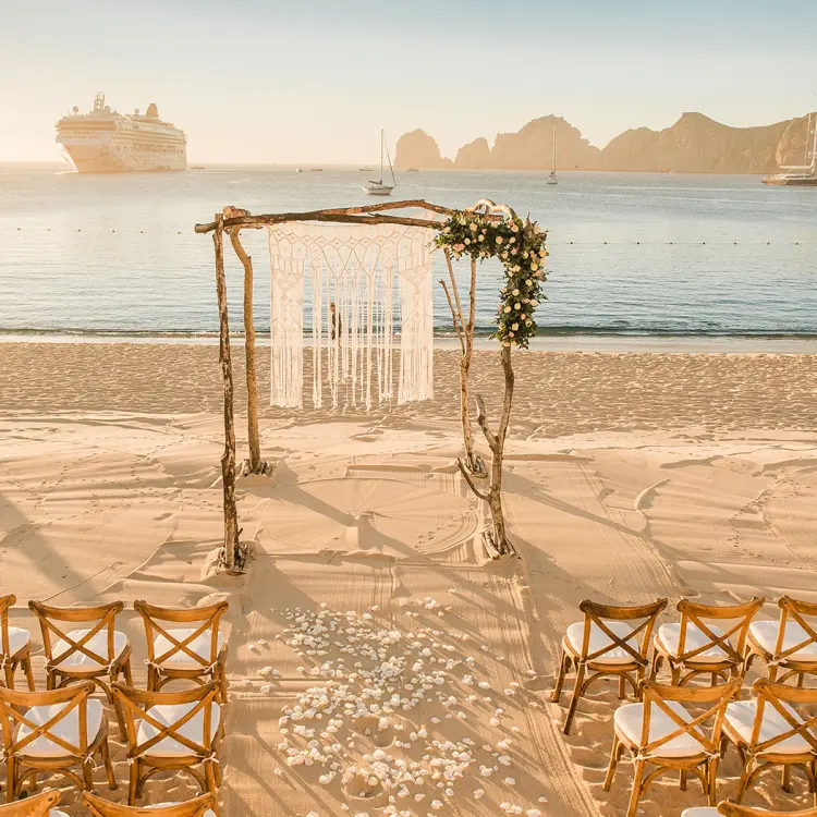 Beachfront wedding ceremony with a macrame arch at Pueblo Bonito Los Cabos, Cabo San Lucas