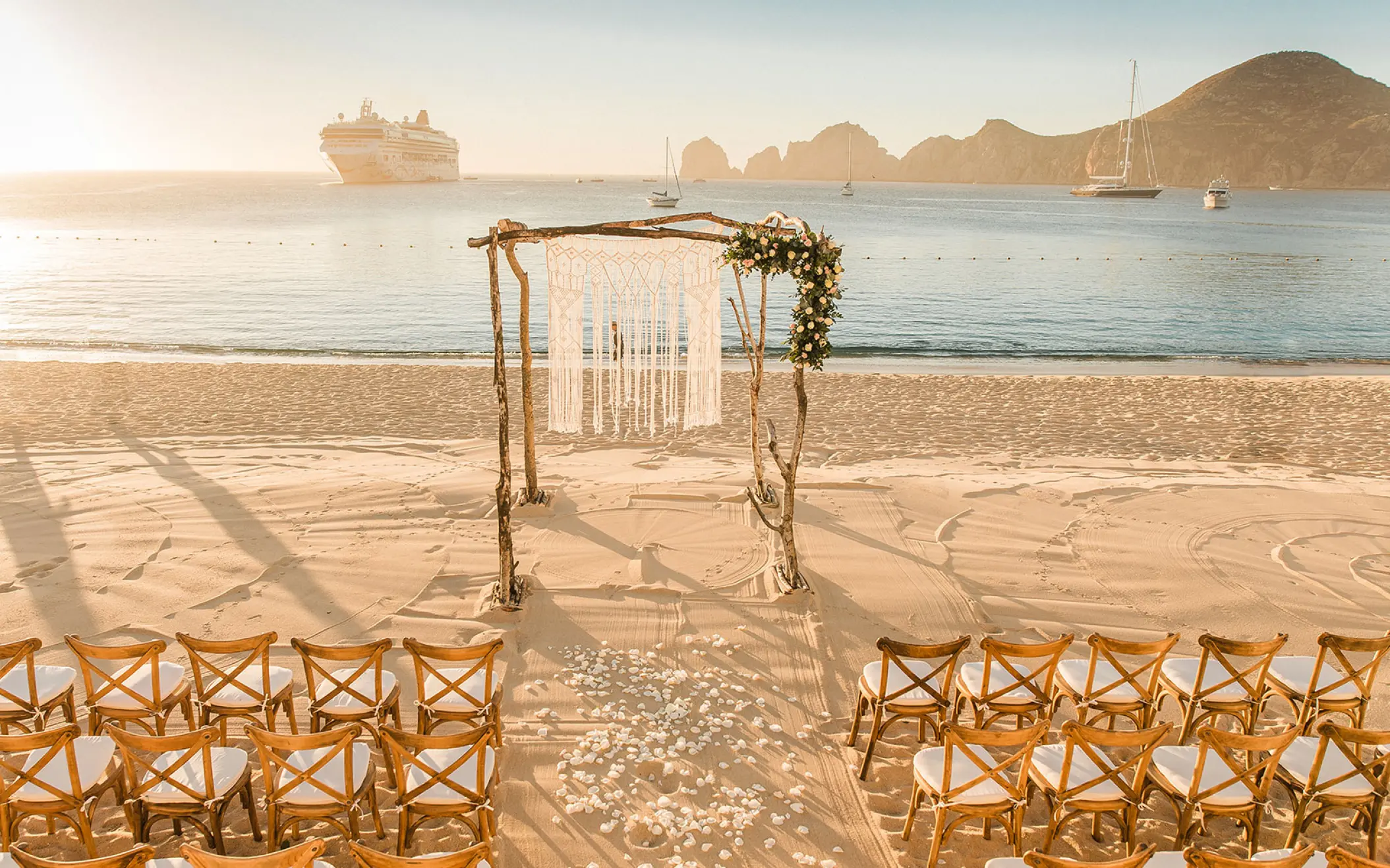 Beachfront wedding ceremony with a macrame arch at Pueblo Bonito Los Cabos, Cabo San Lucas