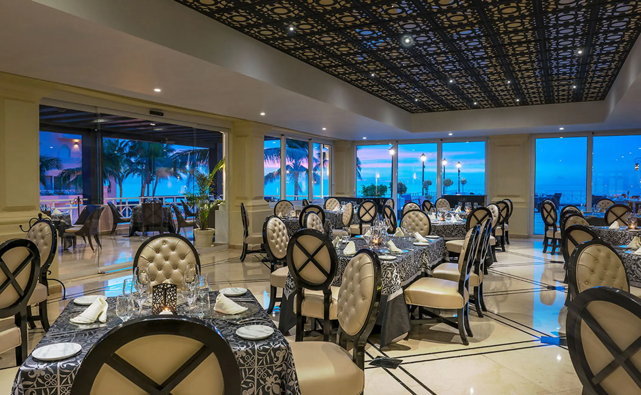 Elegant indoor restaurant with large windows at Pueblo Bonito Rose, Cabo San Lucas