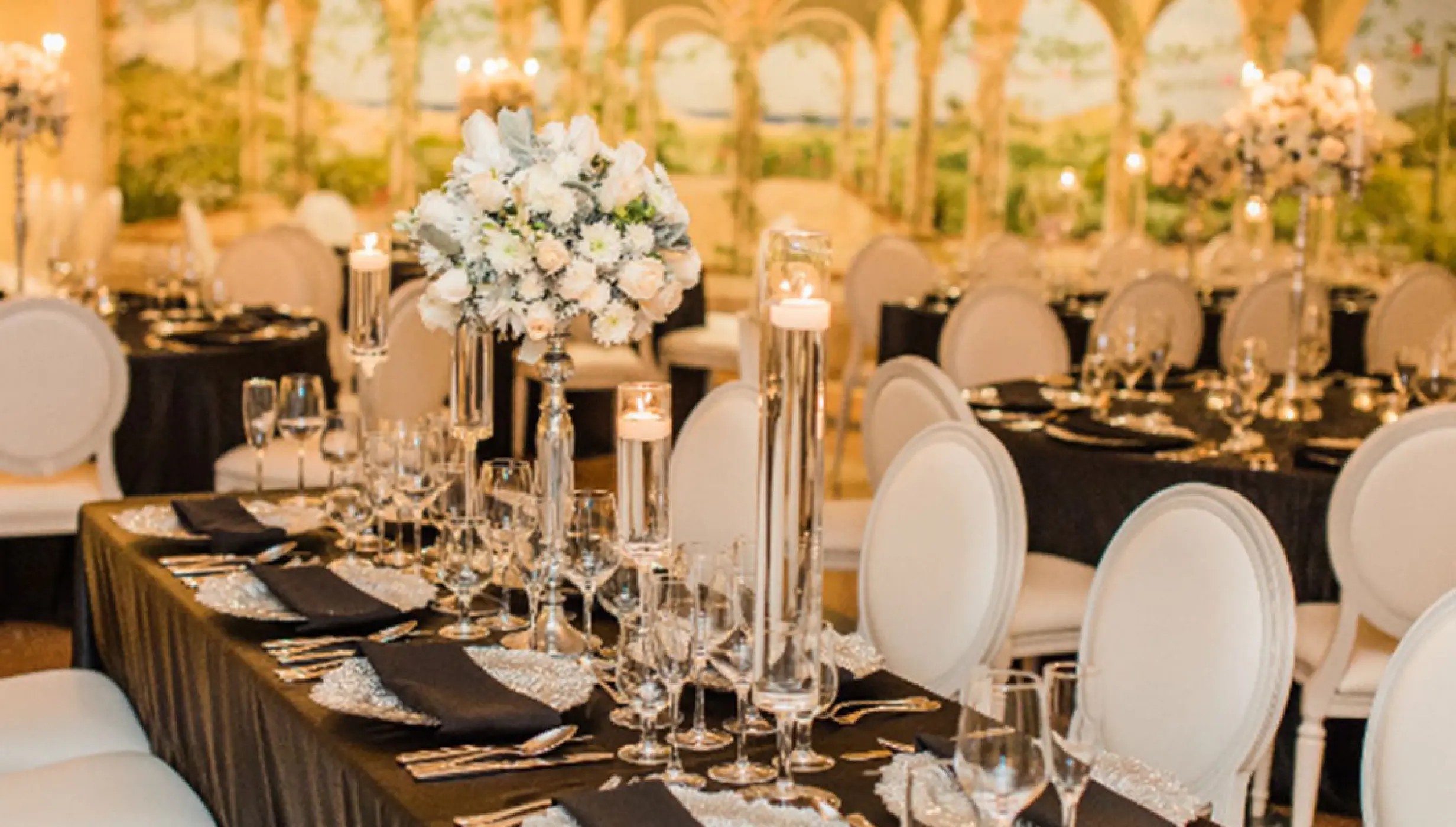Ballroom wedding reception with black linens and white flower centerpieces at Pueblo Bonito Rose, Cabo San Lucas