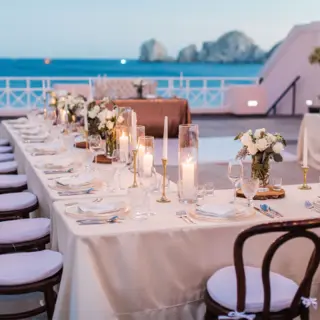 Bella Vita Terrace wedding reception with long tables and ocean views at Pueblo Bonito Rose, Cabo San Lucas