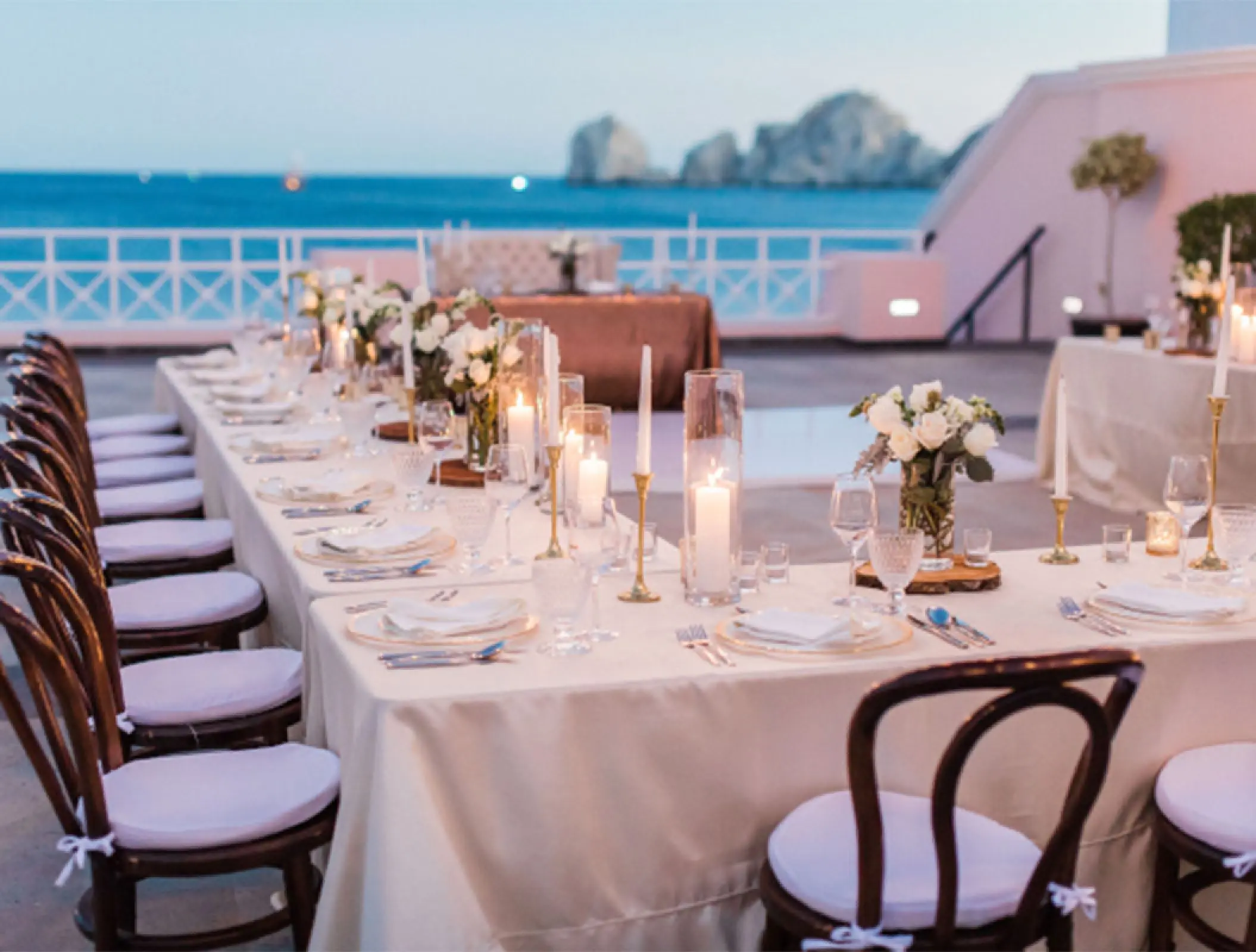 Bella Vita Terrace wedding reception with long tables and ocean views at Pueblo Bonito Rose, Cabo San Lucas