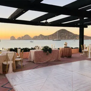 Outdoor wedding reception setup with dance floor on a terrace at Pueblo Bonito Rose, Cabo San Lucas
