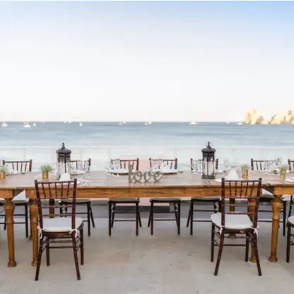 Long wooden table reception setup on Palomas Terrace at Pueblo Bonito Rose, Cabo San Lucas
