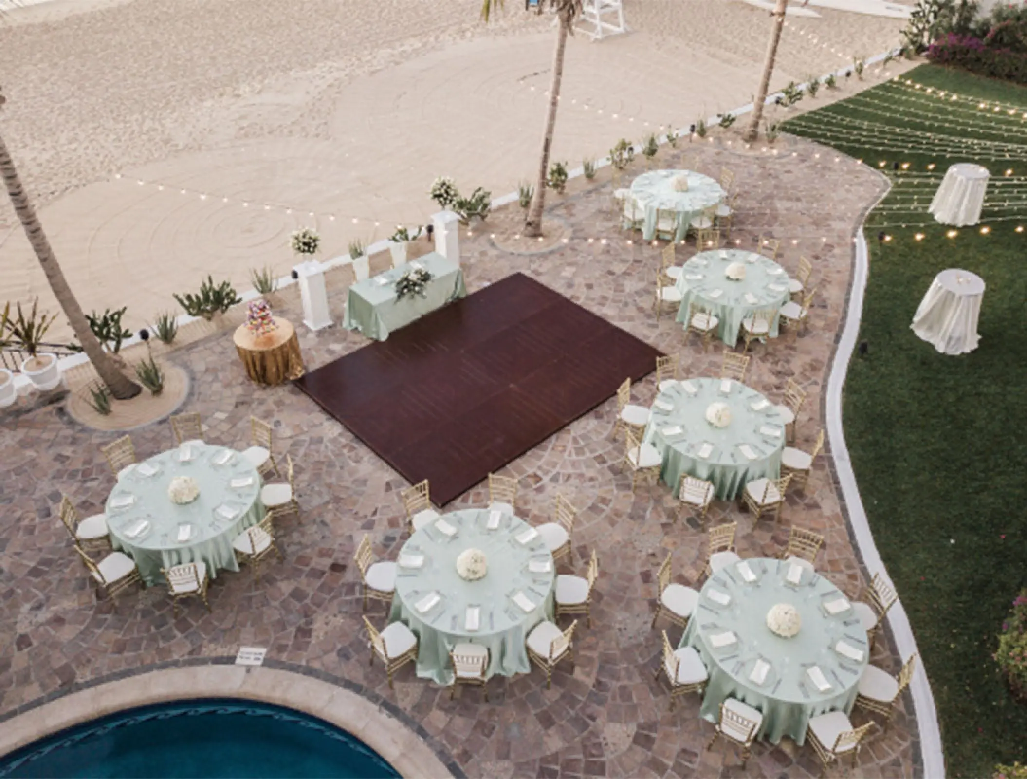 Outdoor wedding reception setup with mint green linens and dance floor at Pueblo Bonito Rose, Cabo San Lucas