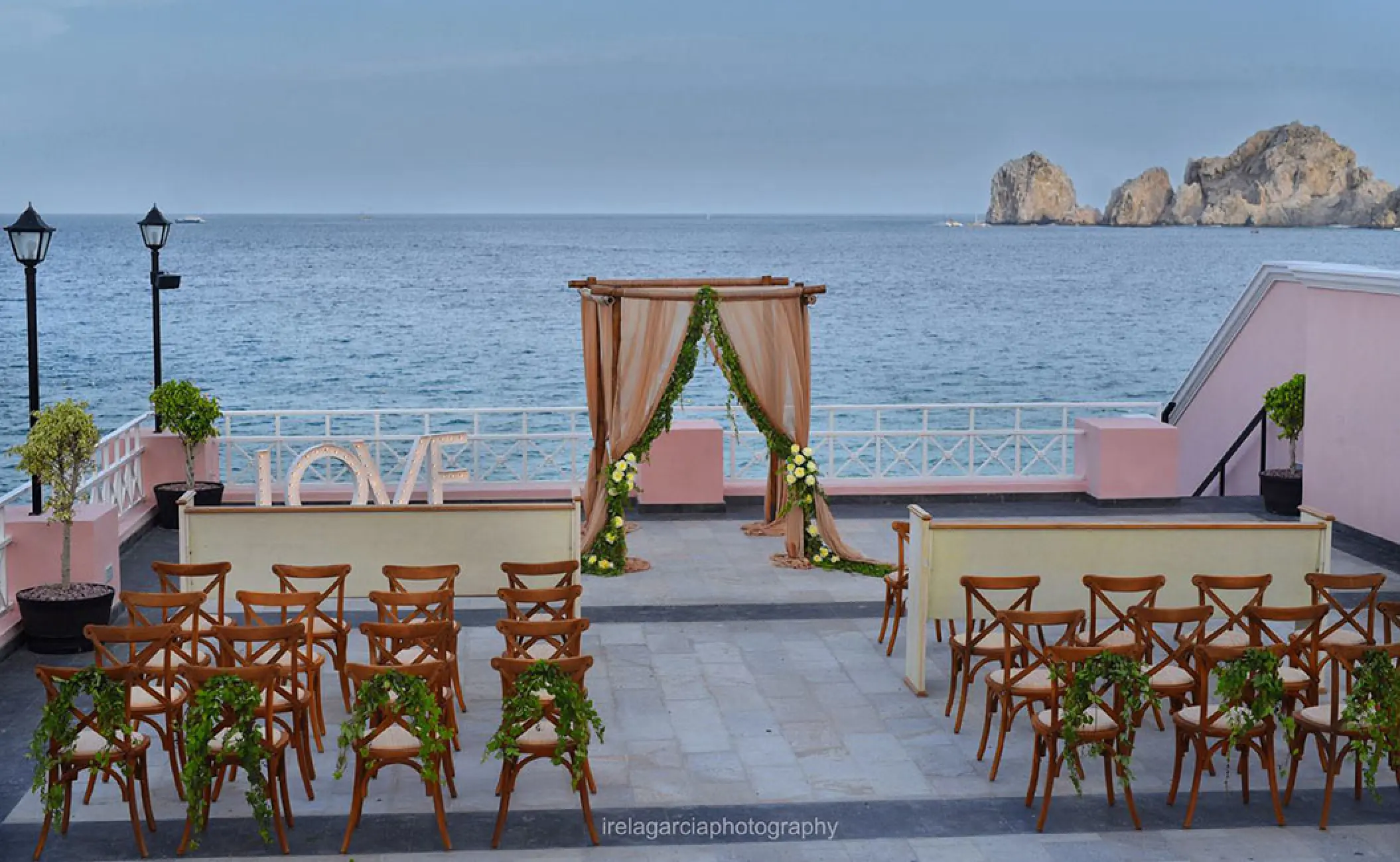 Oceanfront wedding ceremony on a pink terrace at Pueblo Bonito Rose, Cabo San Lucas