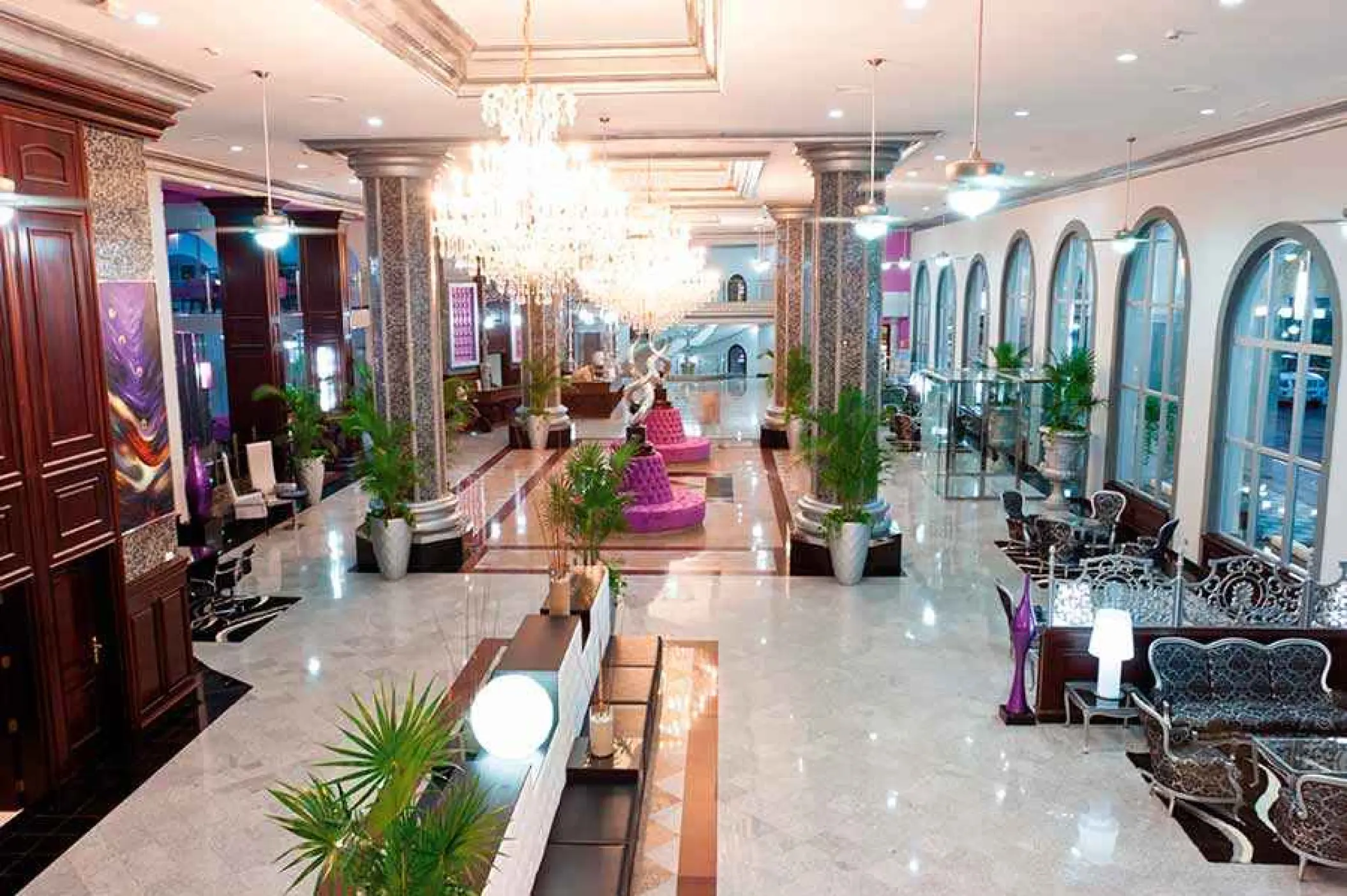 Grand lobby with crystal chandeliers and arched windows at Riu Palace Mexico, Playa Del Carmen