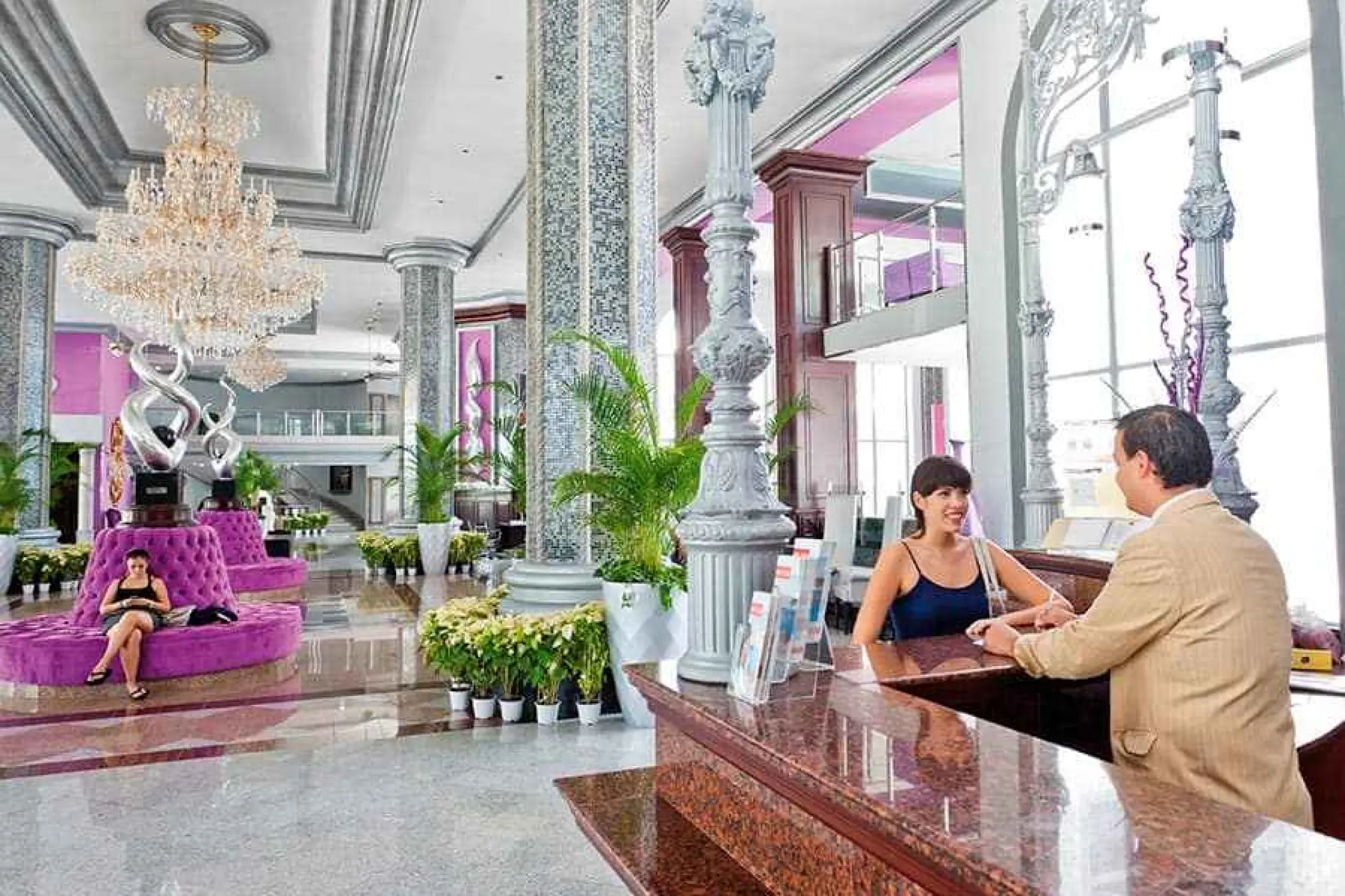 Grand lobby with crystal chandeliers and purple seating at Riu Palace Mexico, Playa Del Carmen