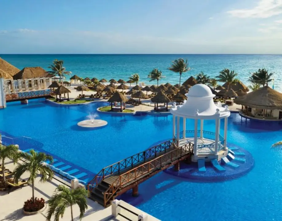 White wedding gazebo in the center of a resort pool with ocean views, Riviera Maya