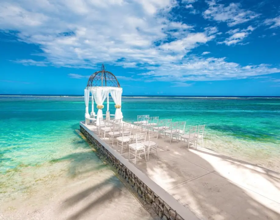 Overwater wedding ceremony gazebo on a jetty overlooking turquoise water in the Caribbean