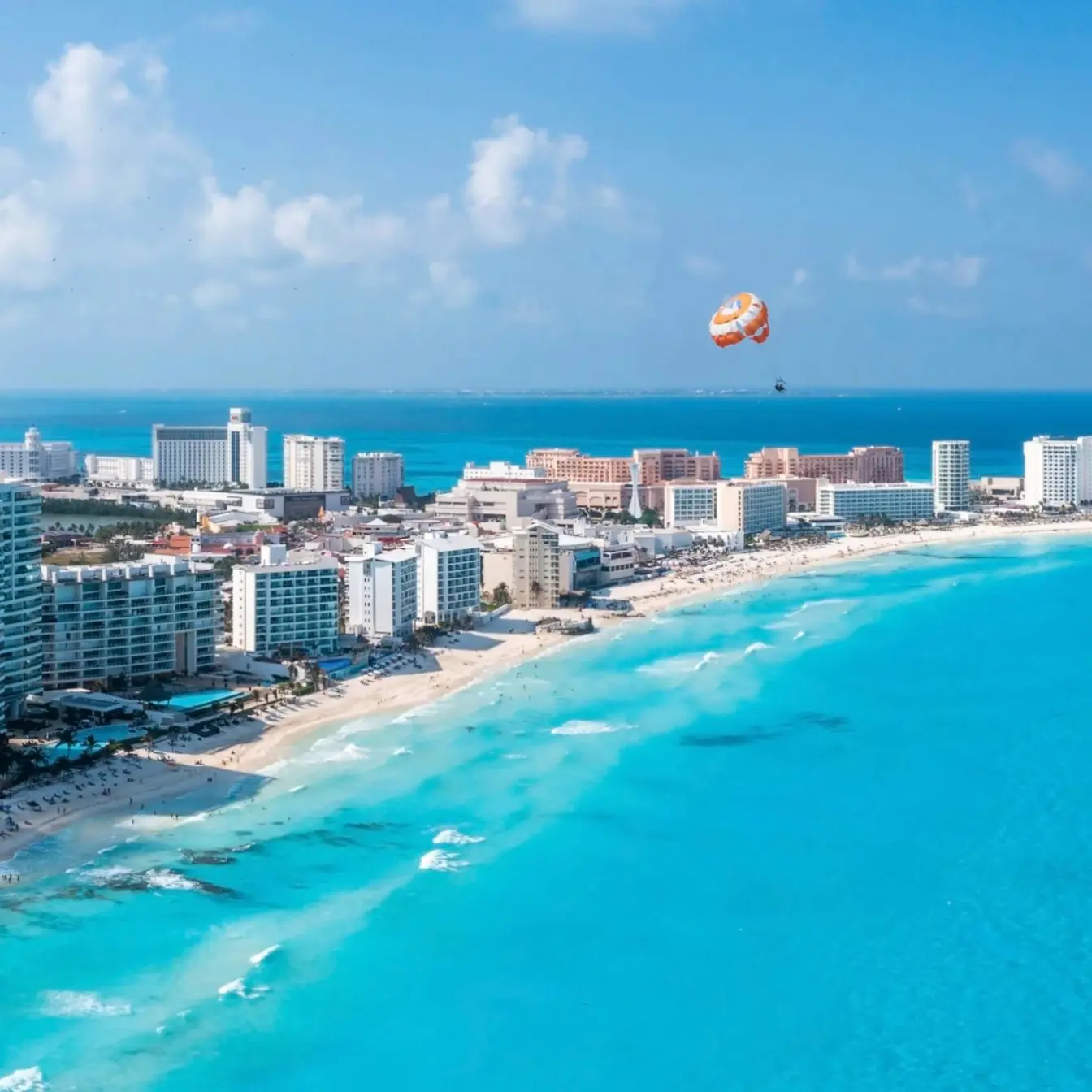 Aerial view of beachfront resorts and turquoise water in the Cancun Hotel Zone