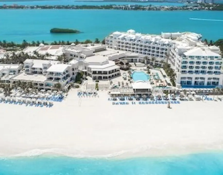 Aerial view of a beachfront Cancun resort with white sand and turquoise water