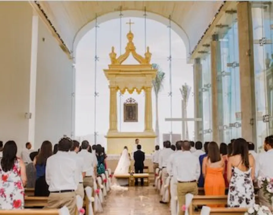 Catholic wedding ceremony in a modern glass-walled chapel, Cancun