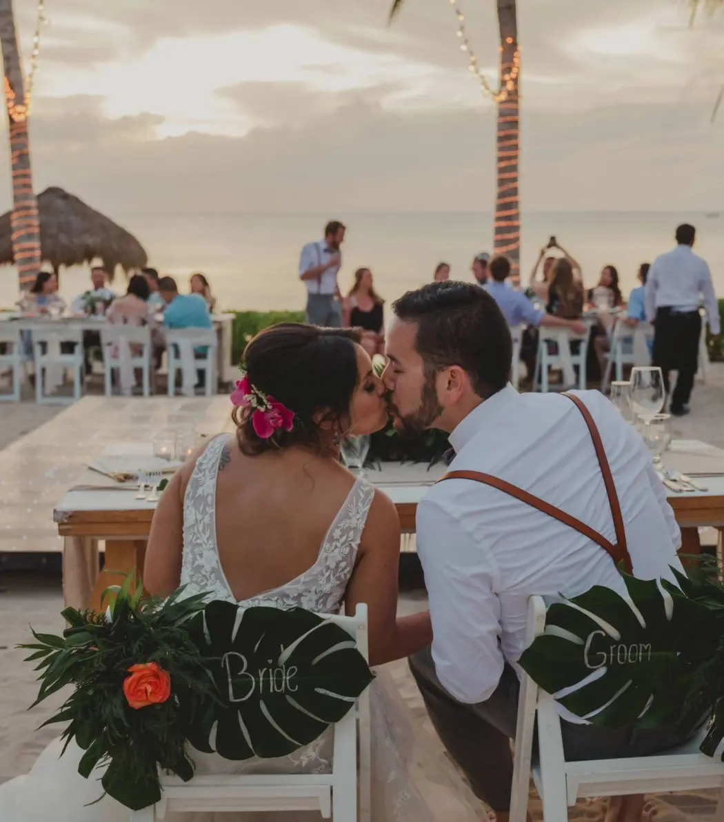 Bride and groom kissing at their beach wedding reception at Dreams Cozumel Cape, Cozumel