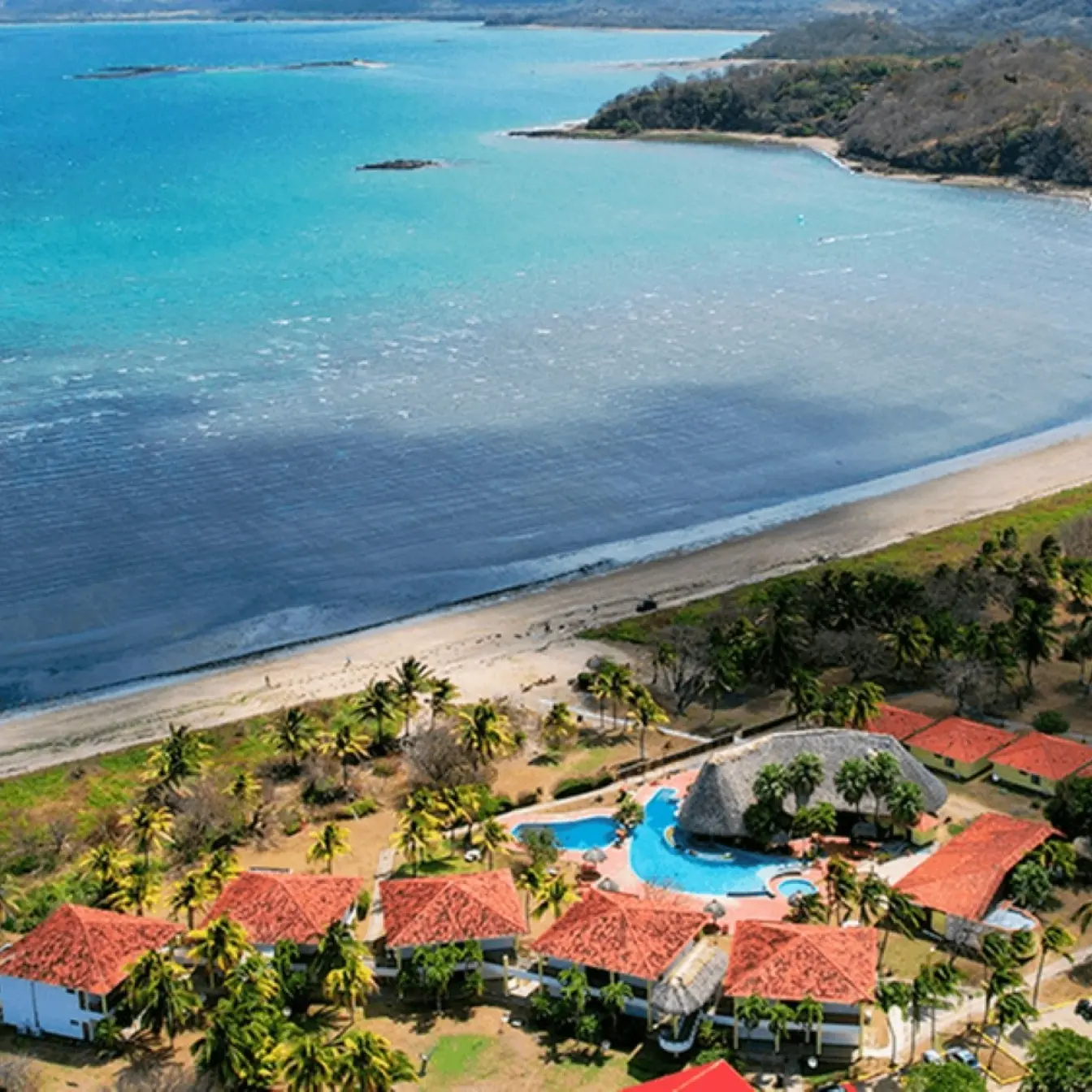 Aerial view of Nandel Beach Resort and the curved coastline of El Jobo, Costa Rica