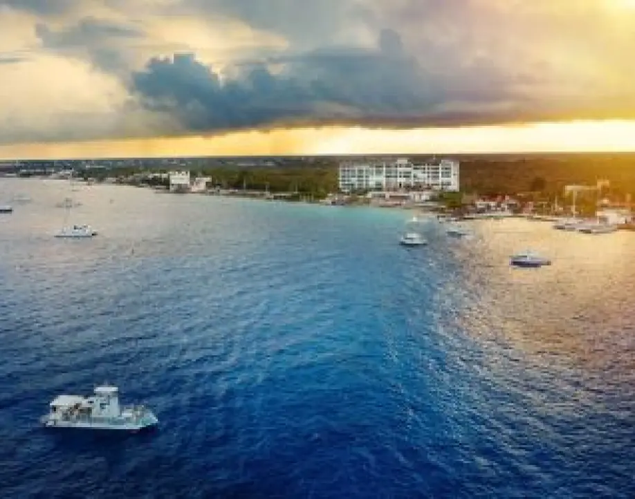 Aerial view of boats in the turquoise Caribbean water near an island resort, Cozumel
