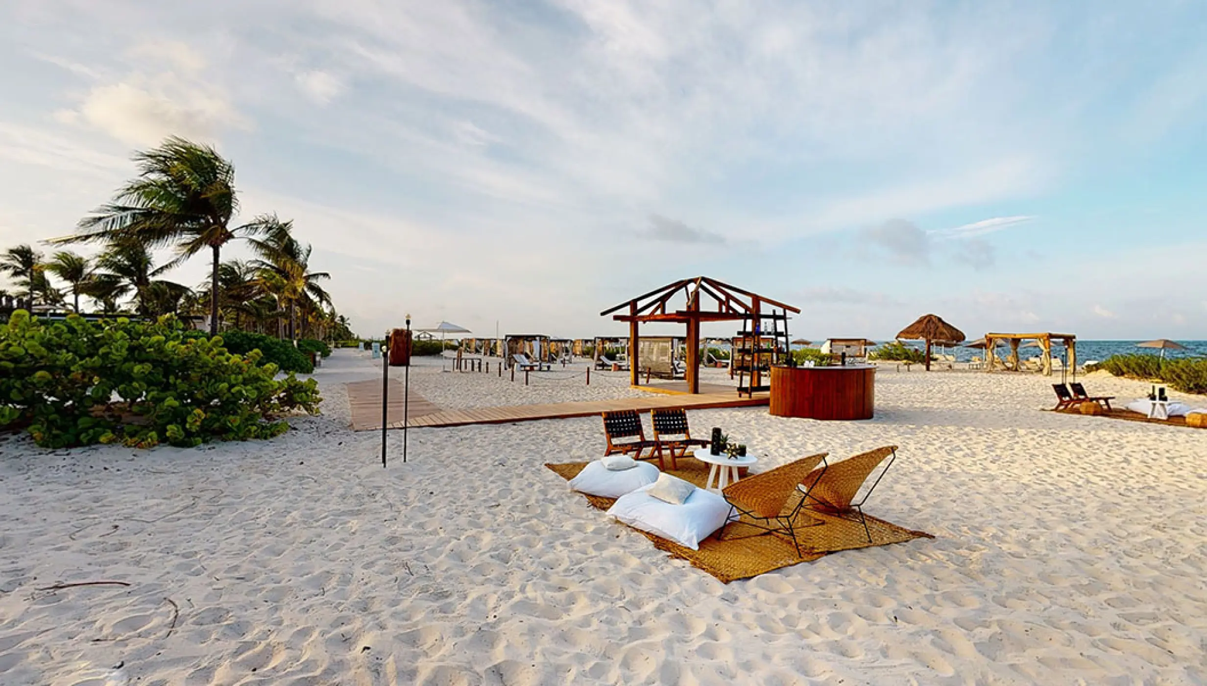 Cocktail setting in beach venue at atelier playa mujeres resort