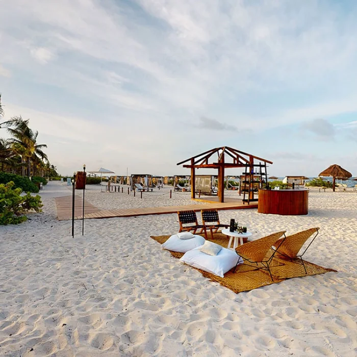 Cocktail setting in beach venue at atelier playa mujeres resort