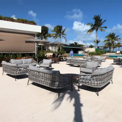 Suspiro Terrace outdoor lounge with gray wicker sofas at Atelier Playa Mujeres, Cancun