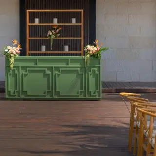 Green outdoor bar and wooden reception tables for a tropical wedding package at Atelier Playa Mujeres, Cancun
