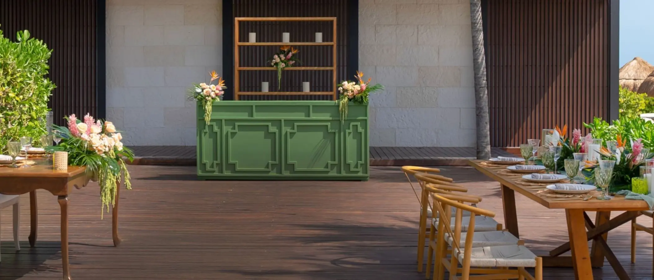 Green outdoor bar and wooden reception tables for a tropical wedding package at Atelier Playa Mujeres, Cancun
