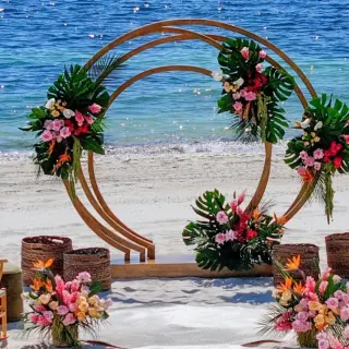 Circular beach wedding ceremony arch with tropical flowers at Atelier Playa Mujeres, Cancun