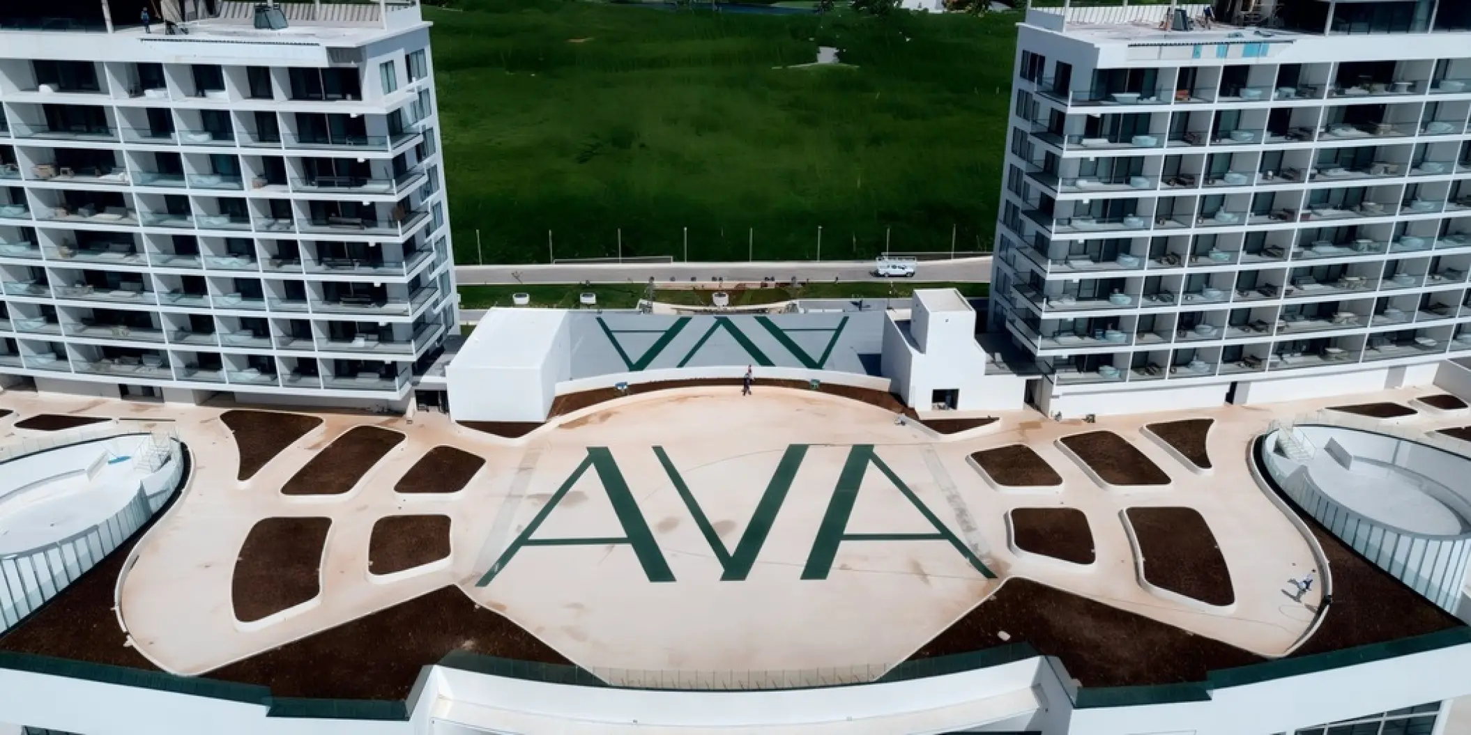 Aerial view of the AVA terrace venue between two modern towers at AVA Resort Cancun