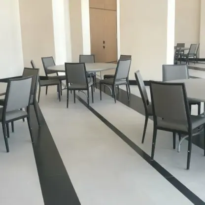 Modern ballroom wedding reception setup with round tables and grey chairs at AVA Resort Cancun
