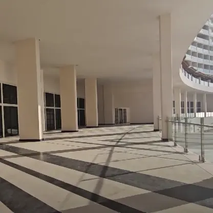 Modern panoramic terrace with glass railings and white pillars at AVA Resort Cancun